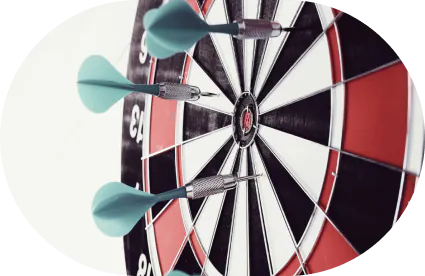 A dartboard with several darts stuck in it