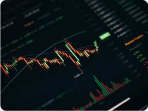 Dark-mode candlestick stock chart on a screen of tablet